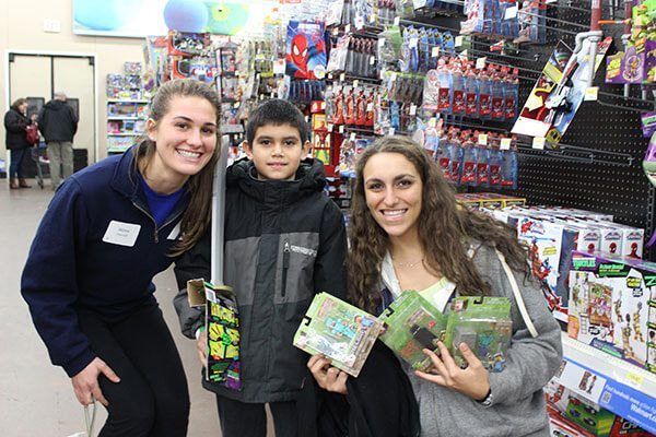 Two young girls helping make a difference with EAC during last holiday season