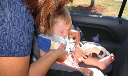 Baby being buckled in; Safe Start