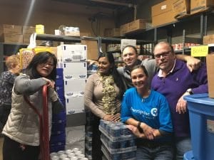 Volunteers from Ameriprise help organize the food pantry for Nutrition Education