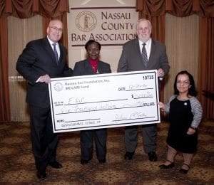From left to right: Marc C. Gann, WE CARE Co-Chair; Dorothy Worrell, Program Director of Nassau Supervised Visitation; Lance W. Elder, President & CEO, EAC Network; and Sarika Kapoor, WE CARE Co-Chair.