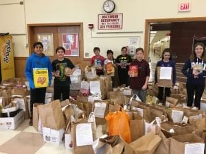Students from Island Trees School District proudly pose with their food donations.