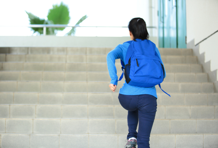 A former children and youth services participants runs up the steps.