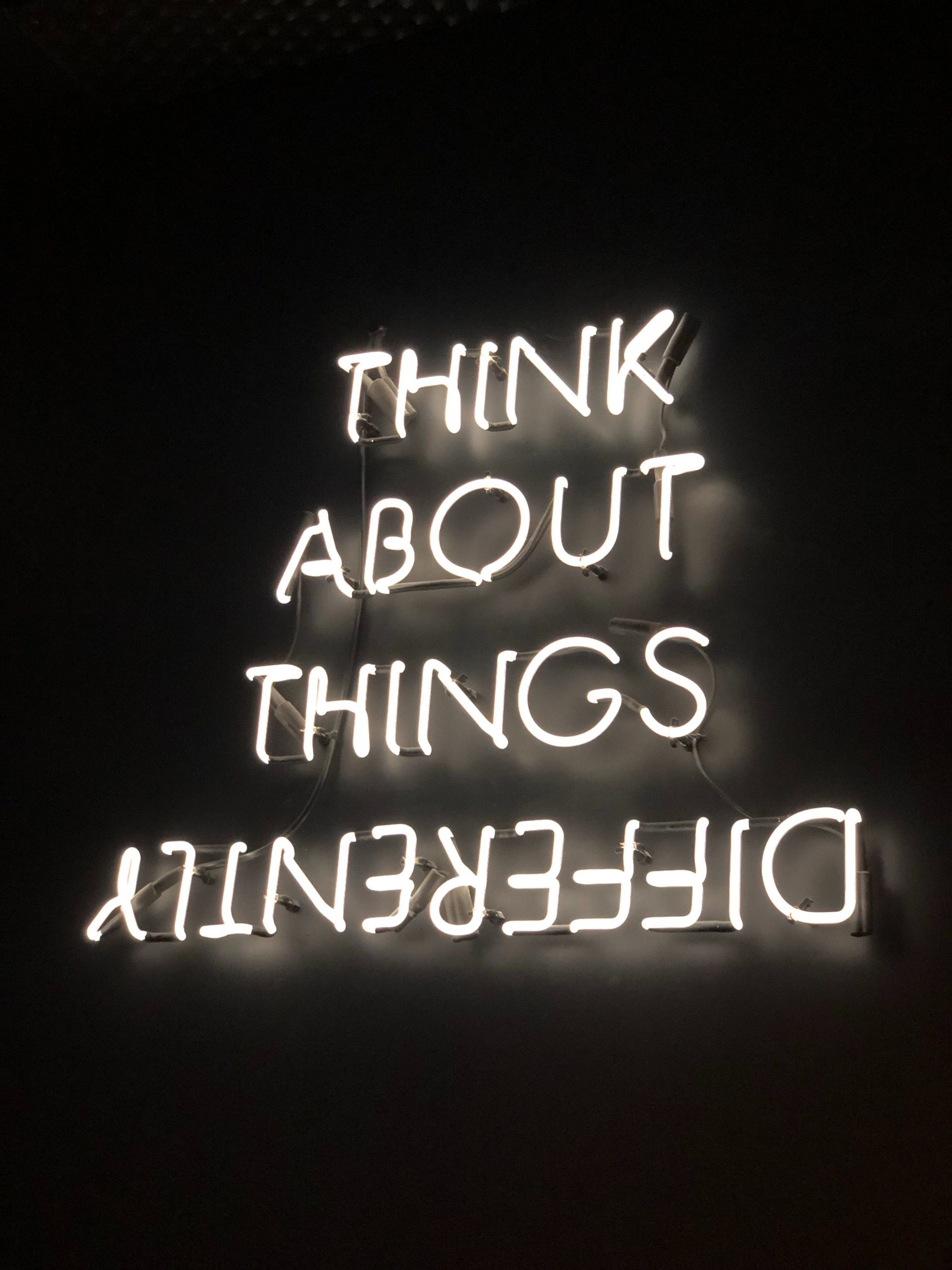 Neon lights that say Think ABout Things DIfferently