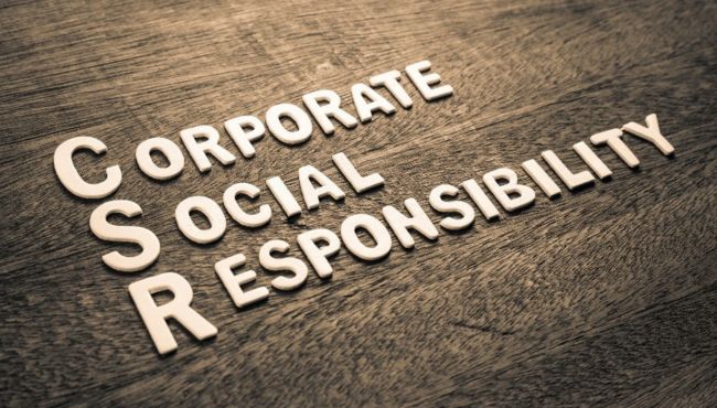 corporate social responsibility written out on a wooden background