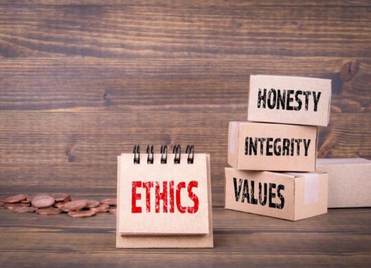 blocks of wood stacked that have honesty, integrity values and ethics on them