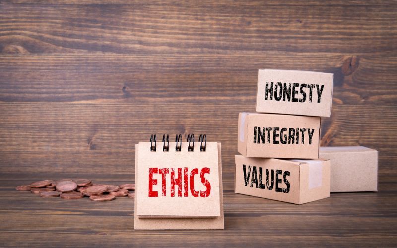 blocks of wood stacked that have honesty, integrity values and ethics on them