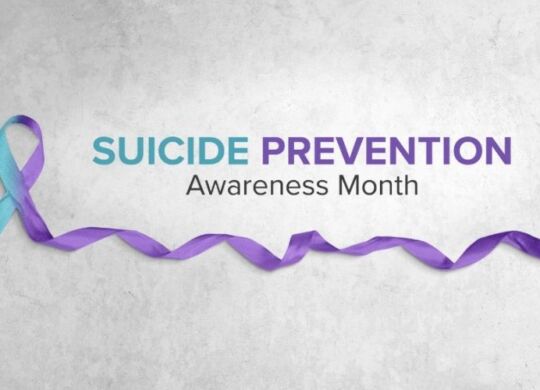 suicide prevention awareness month written out with an accompanying ribbon