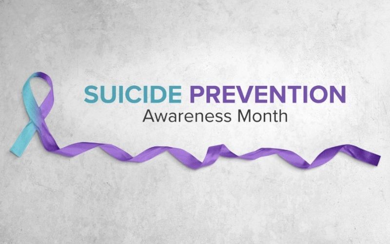 suicide prevention awareness month written out with an accompanying ribbon