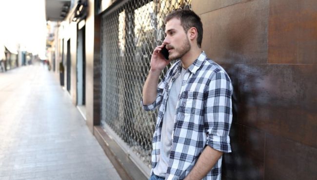 man on cell phone having a serious call outdoors