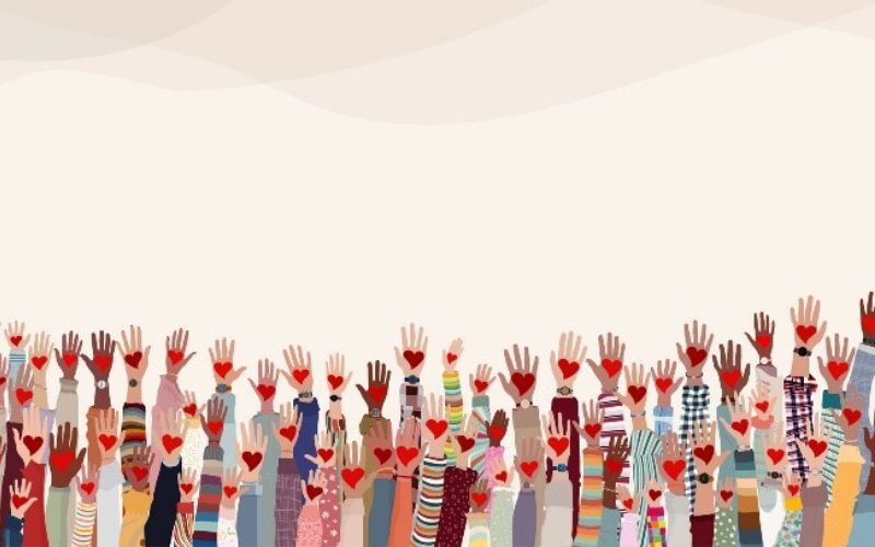 artwork showing dozens of arms raised inthe air, each with a heart in hand and depicting many different races