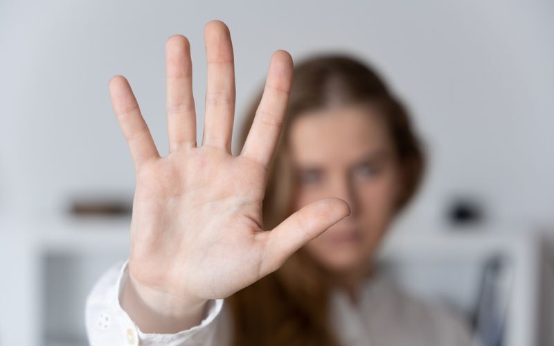 woman putting her hand up to say enough is enough
